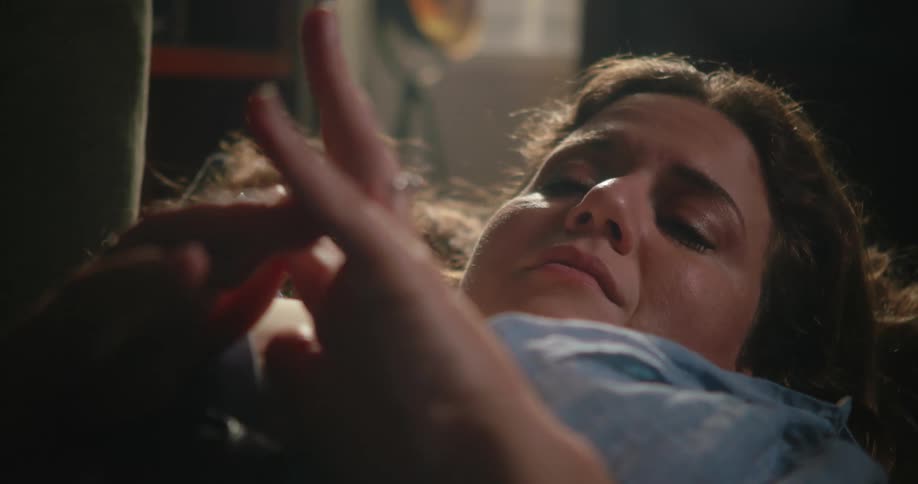 A woman is sad while she lays down