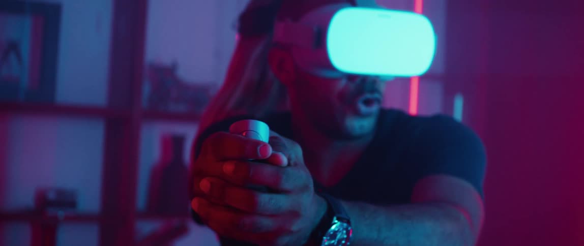 A man playing with a virtual reality headset indoors