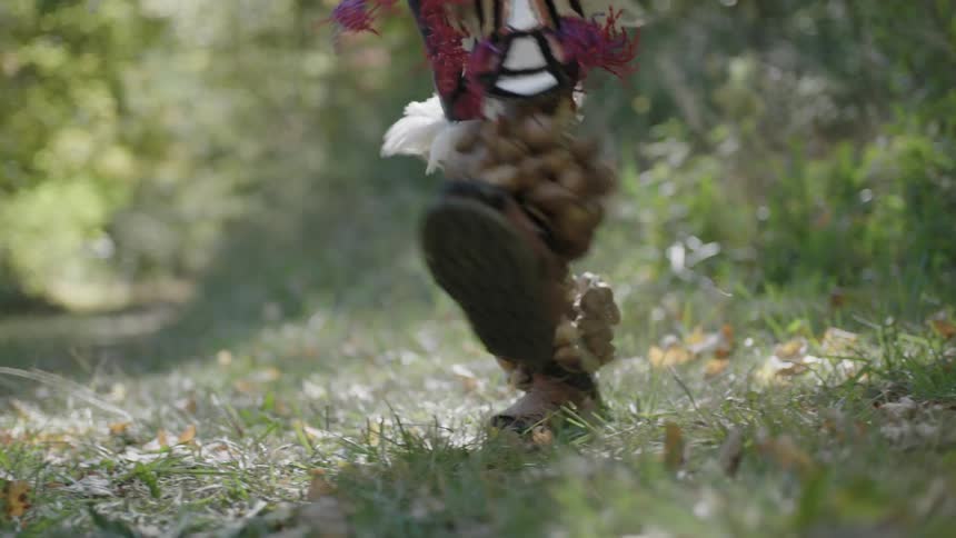 Waist-down view of a tribal person dancing in a decorative costume