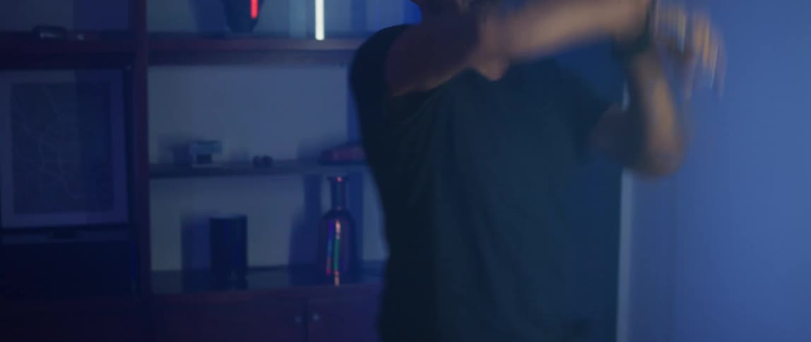 Couple wearing virtual reality goggles playing a tennis video game inside a futuristic looking room