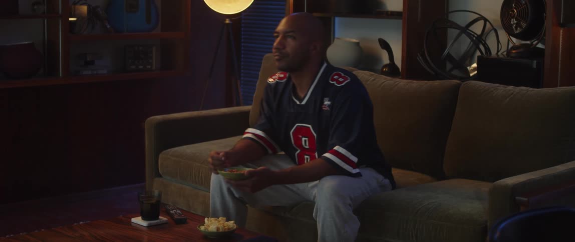 A man gets upset while watching sports at home