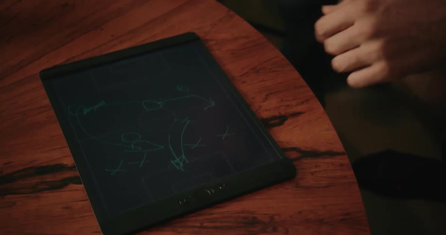 Two men take turns drawing a sketch on a tablet at home