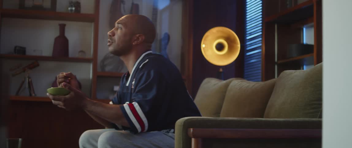 A man cheers on his couch