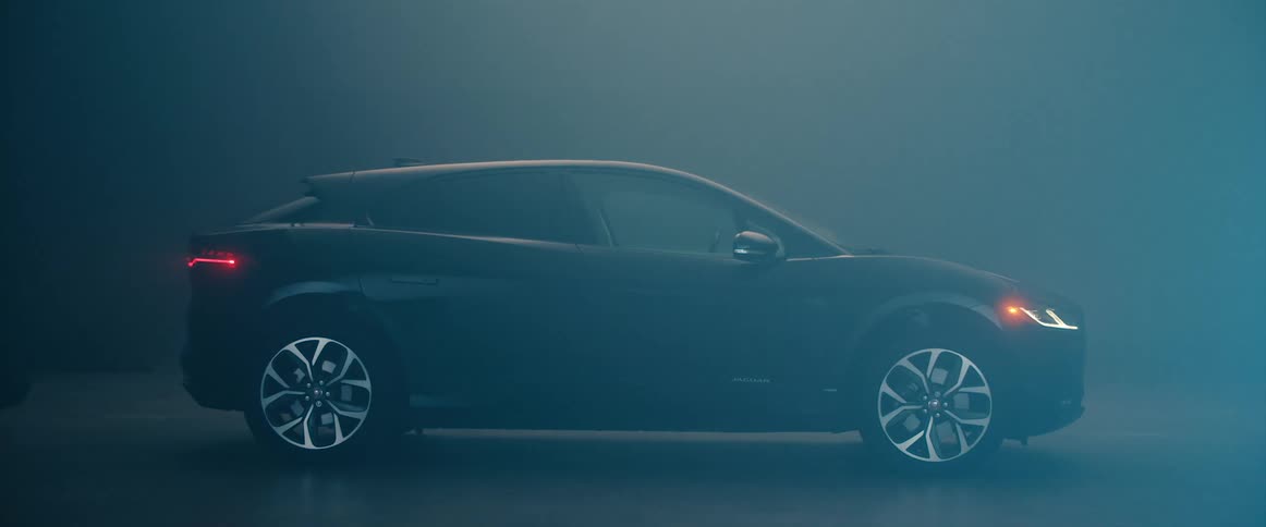 A light comes on over a hatchback vehicle in a garage