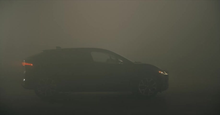 A parked car on a dark foggy night