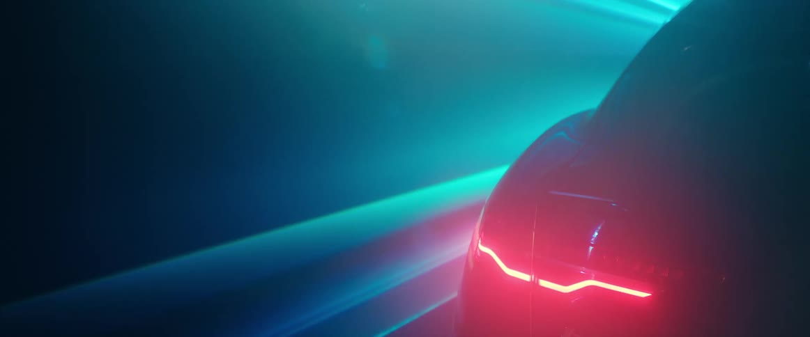 Blue lights and spotlight move over and past vehicle with lit taillight