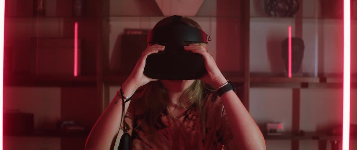 A woman puts on a virtual reality headset