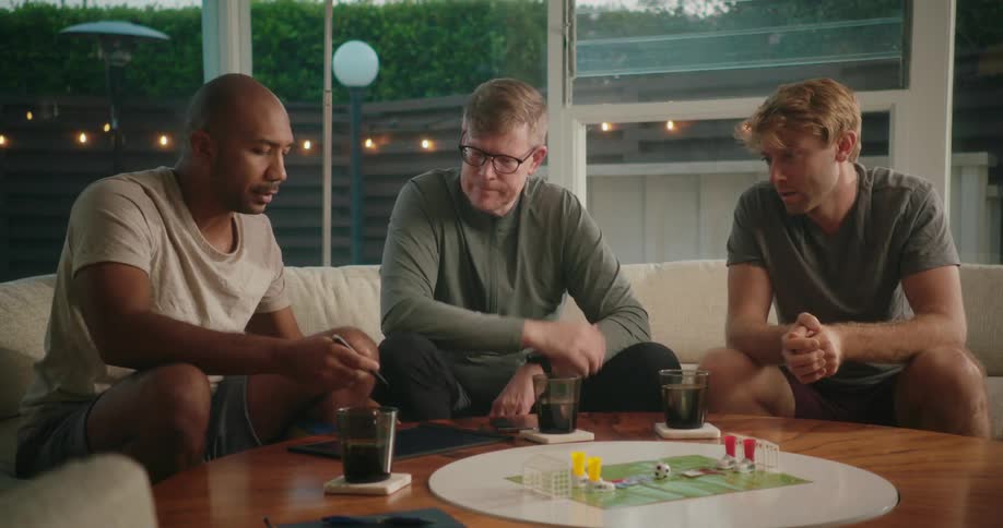 A group of friends are hanging out together and playing a game