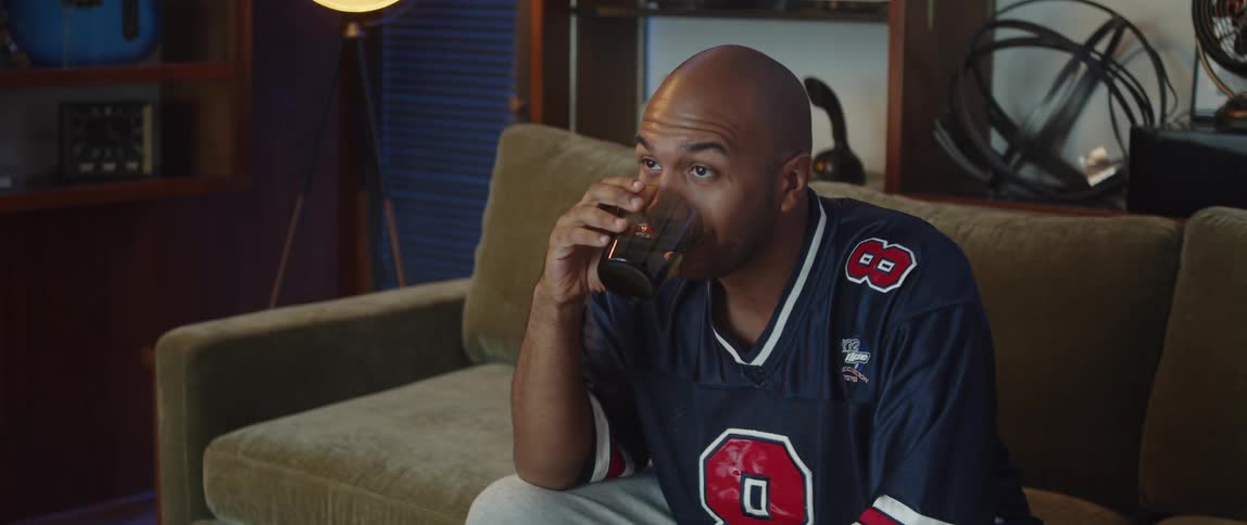 A man sitting around watching sports on tv