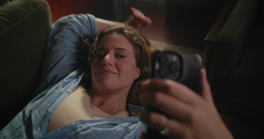 A woman laying around using a smartphone
