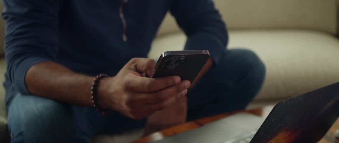 A man is typing on his cell phone