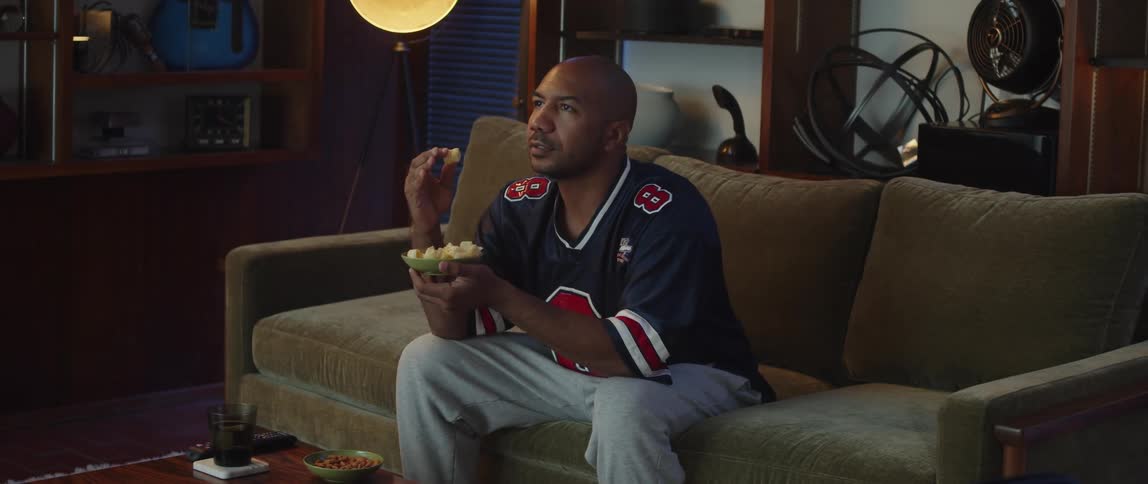 A man sitting around watching sports