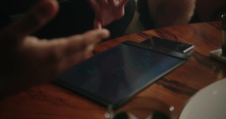 People using a tablet in a room