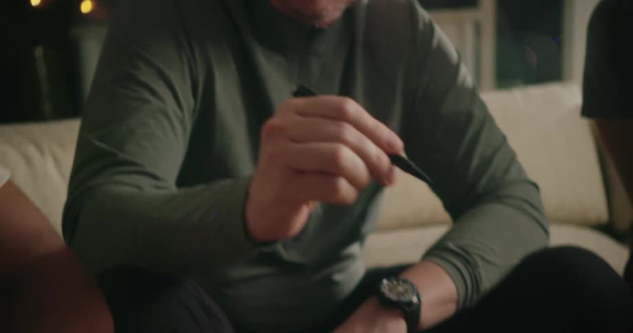A group of people sitting around using a tablet