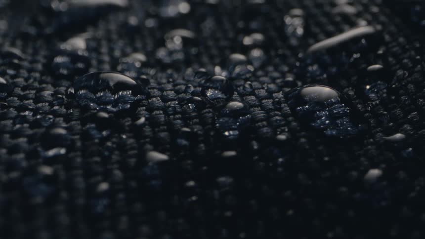 Drops of water are on a dark fabric