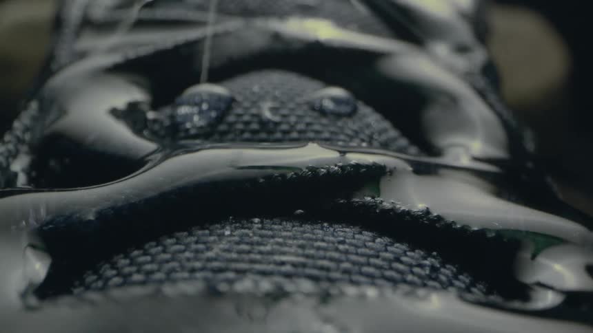 Droplets of water pool as rain falls during a storm