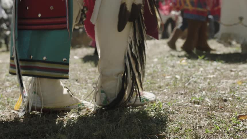 Festively dressed native americans perform a dance