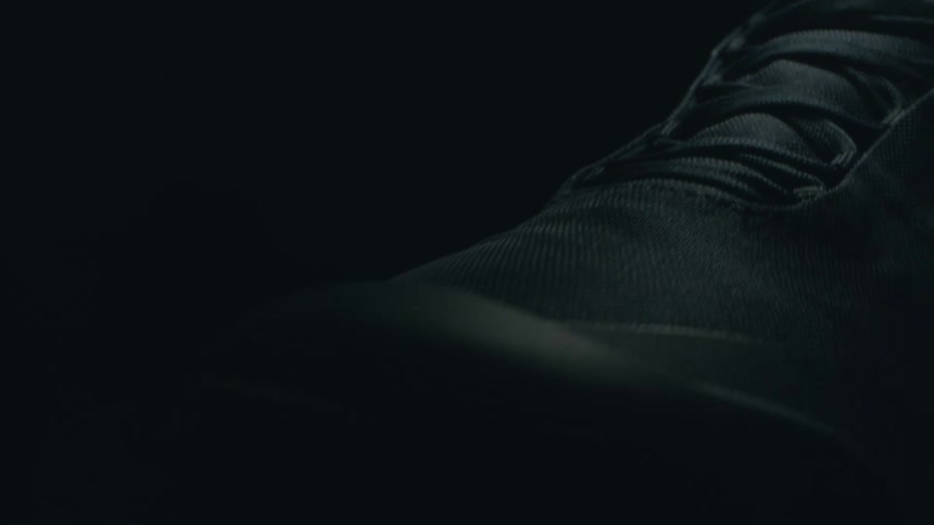 A black shoe with black shoelaces