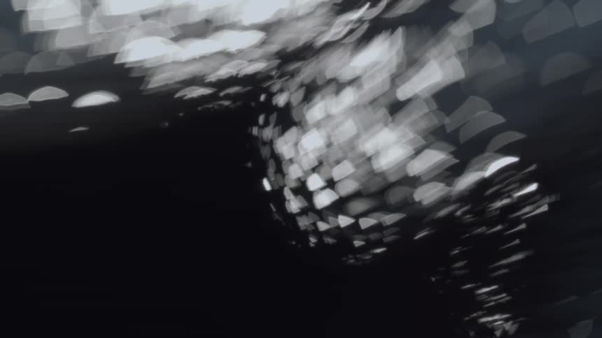 The hand moves under the light