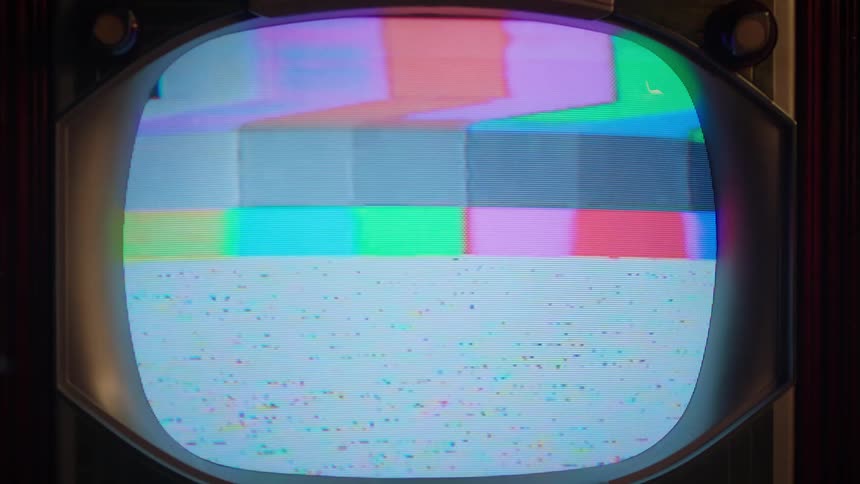An antique television displaying static on the screen