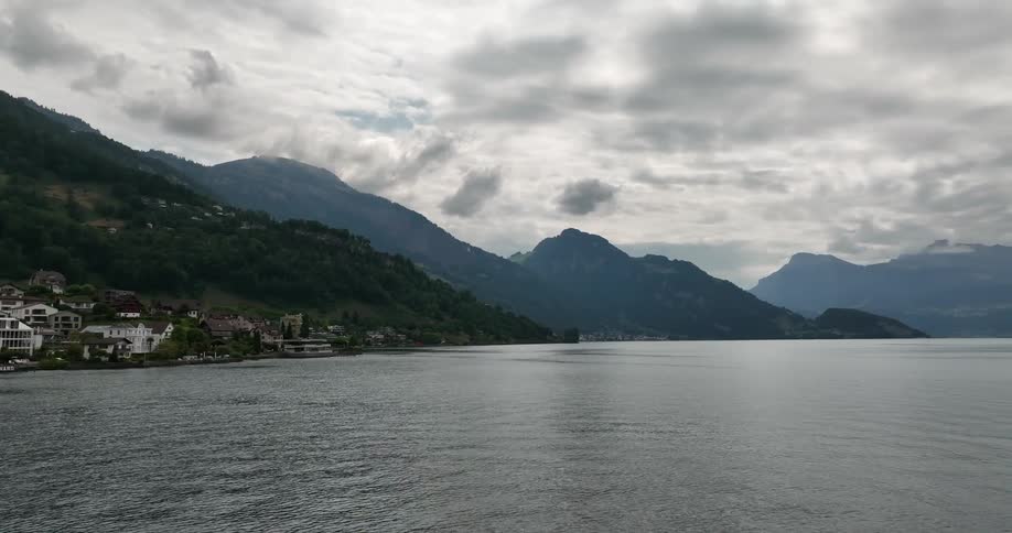 Aerial view of a small coastal european town on the mountains close to a lake