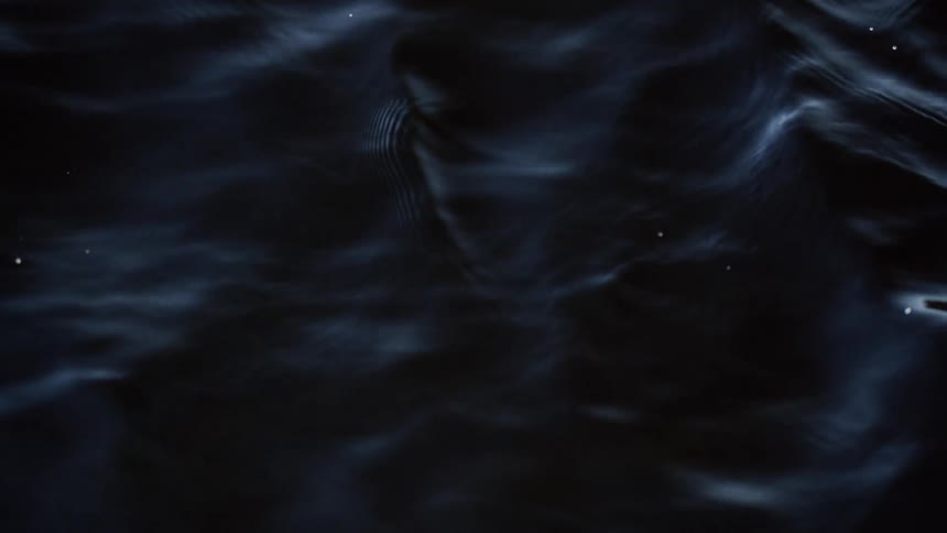 Light shines on the water as it ripples and moves