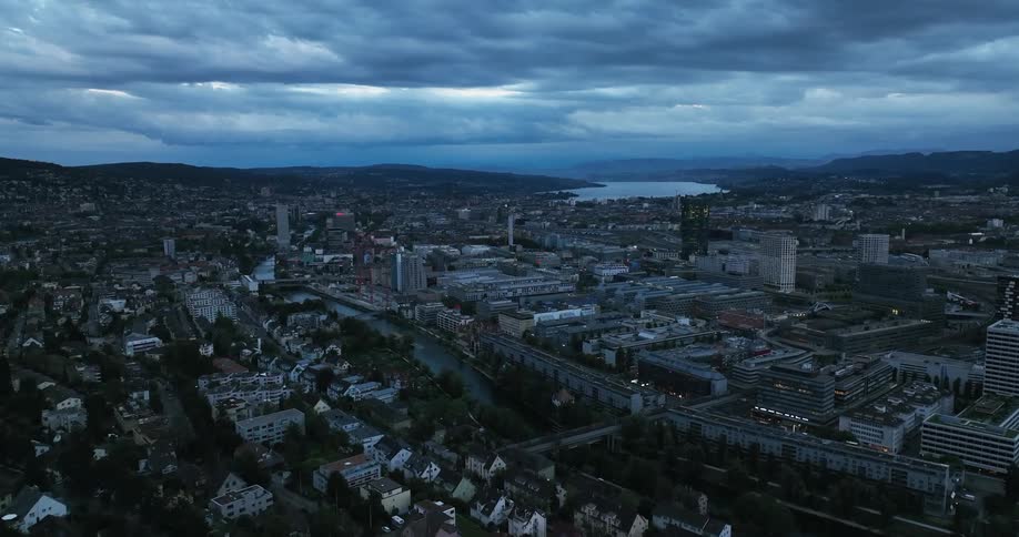A river runs through the mountains into a large city