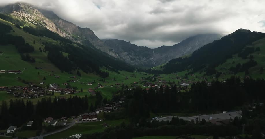 Aerial view of town in green valley between mountains