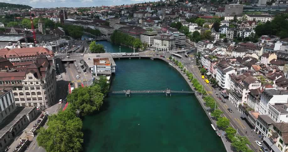 Traffic moves on bridges that cross a river in a mountain town