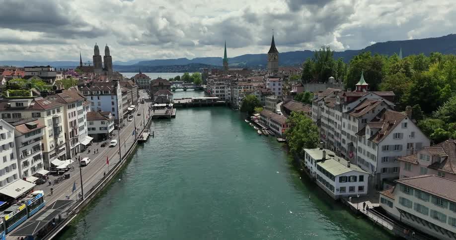 People and traffic pass through a historical city along a river