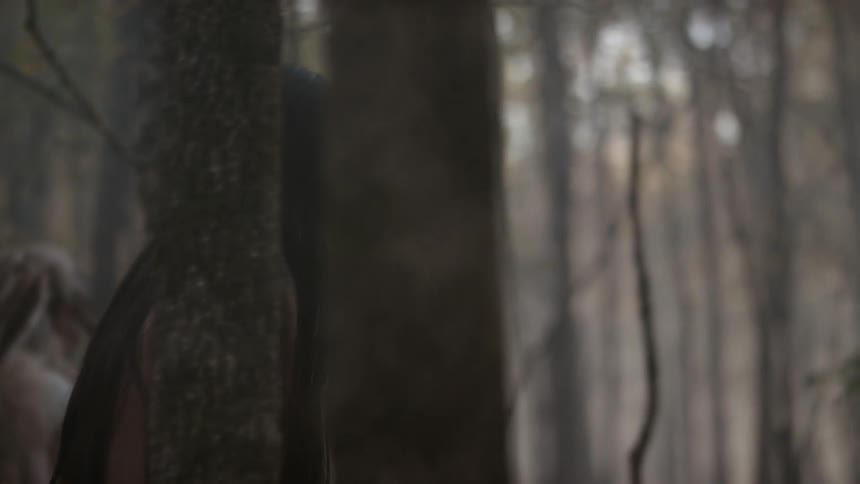 Two native americans walk through the woods
