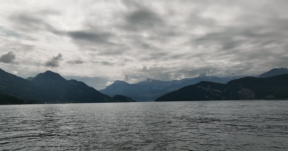 Storm clouds hang over a lake in the mountains