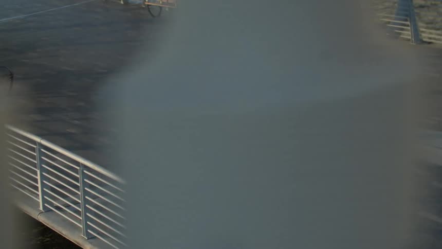 A man is running on a pier next to some cruise ships