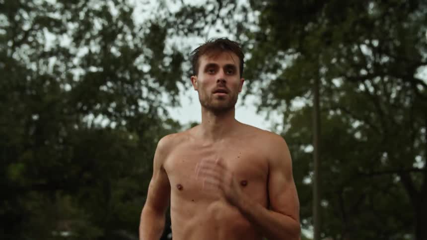 A man is jogging outside on a cloudy day