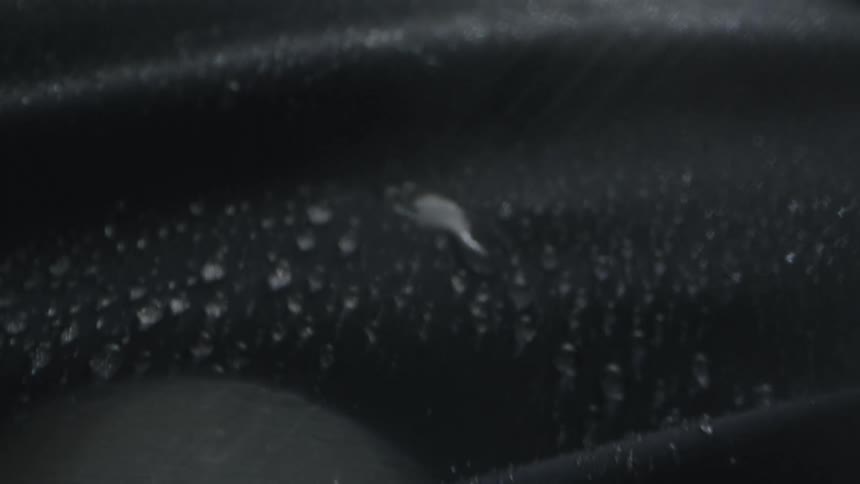 Drops form on fabric as rain falls