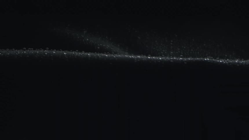 A closeup of a long black sheet with water droplets