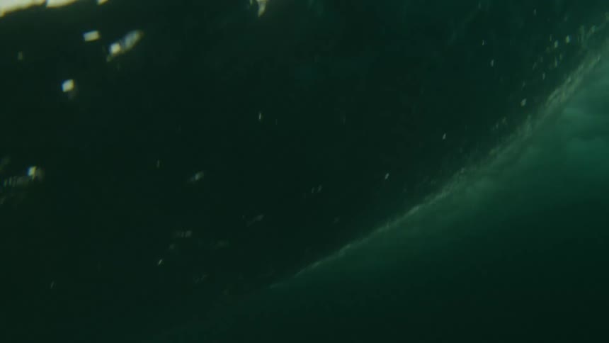 A wave crashes over onto itself in the ocean