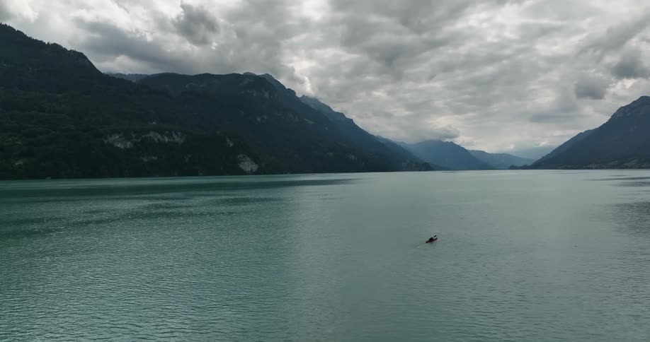 A person paddles a kayak through the ocean