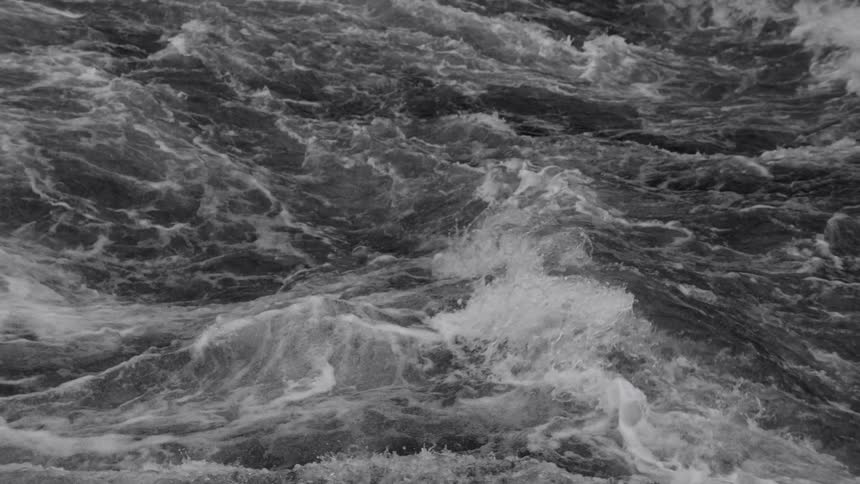 Waves in the ocean are churning and crashing against each other