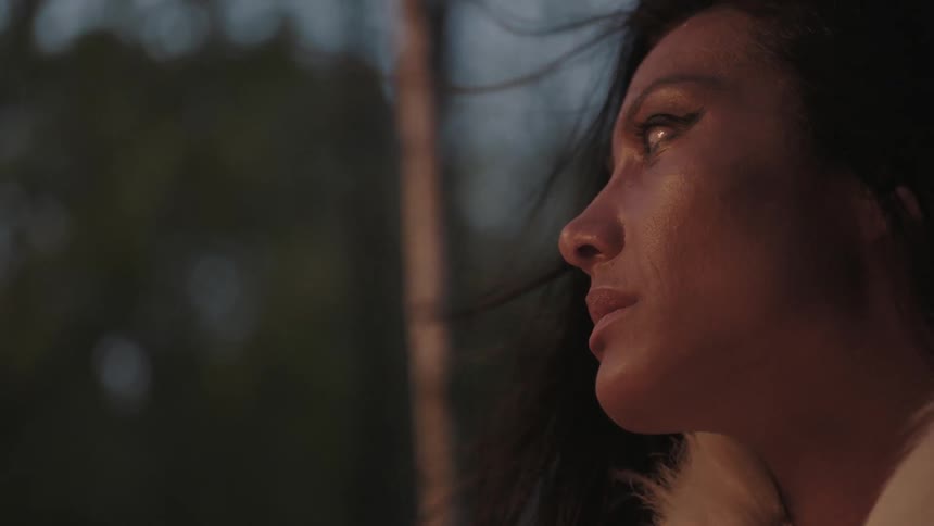A woman with dark hair looks up