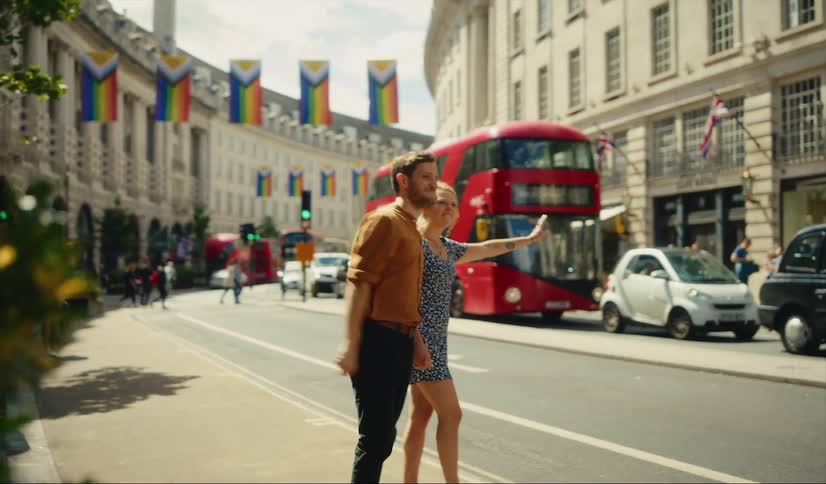A couple hail a taxi on regent street in london on a summer's day