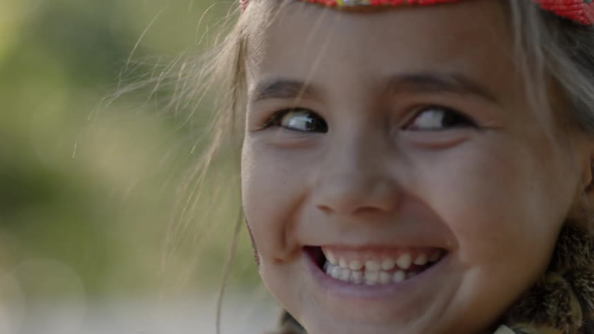 A young girl with a large smile