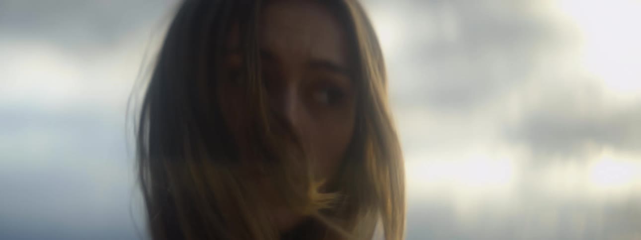 A woman with long hair turning her head to the side