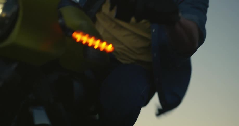 A man sways side to side while riding his motorcycle