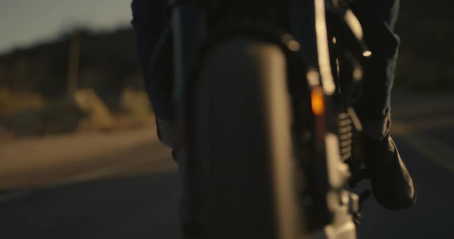 Man driving a motorcycle on the highway during a sunny day