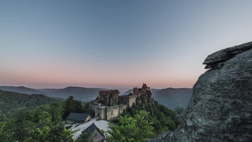 Lights turn on in a castle on a cliff