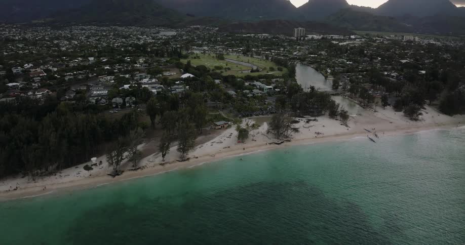 A neighborhood is shown on the beach along with the coast and water with several houses