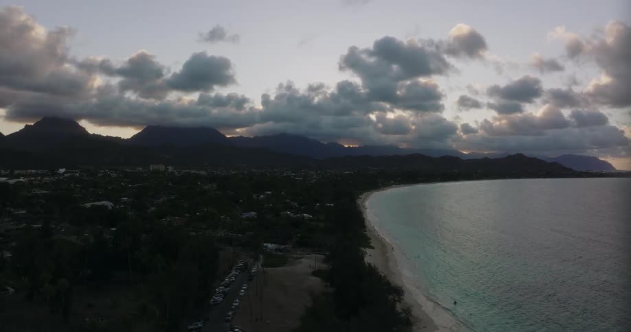 An aerial view of an ocean shoreline at sunset