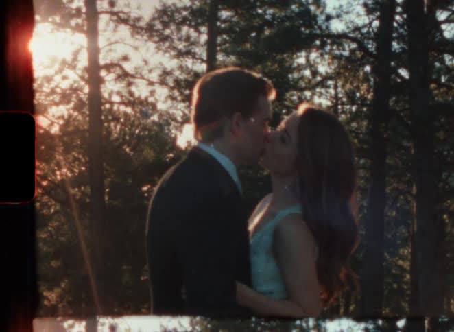 A couple kiss after getting married in the woods in super 8 film