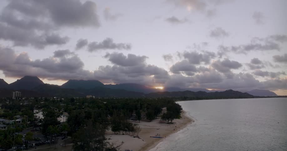 The sun is rising on the shore